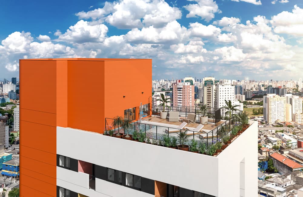 Vista externa da fachada do edifício com bloco superior laranja e piscina na cobertura.
